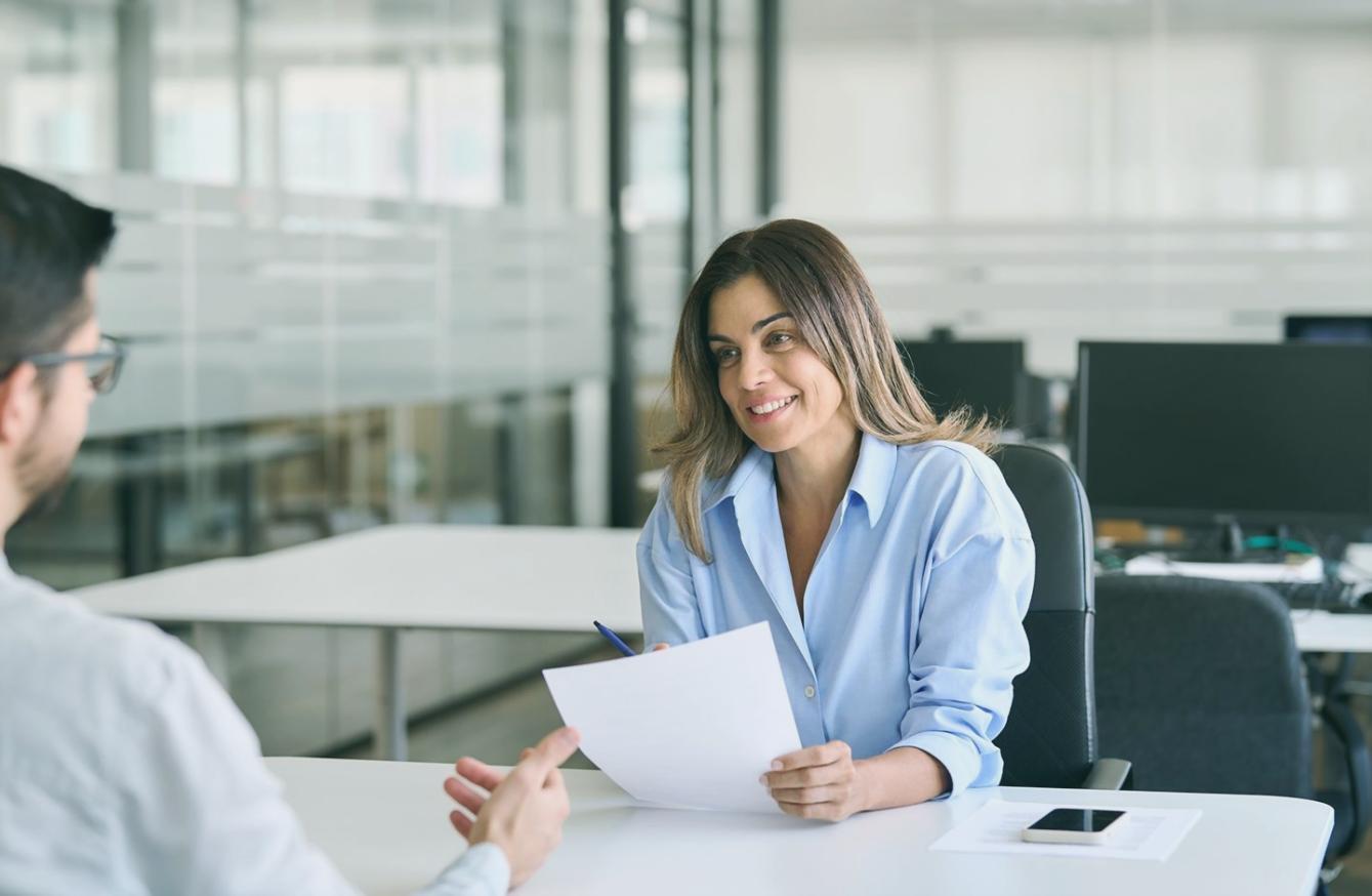 Person reviewing personal budget documents at a desk